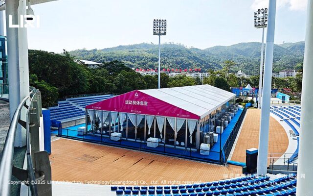 Carpa de atención al público con asientos e instalaciones en un recinto deportivo